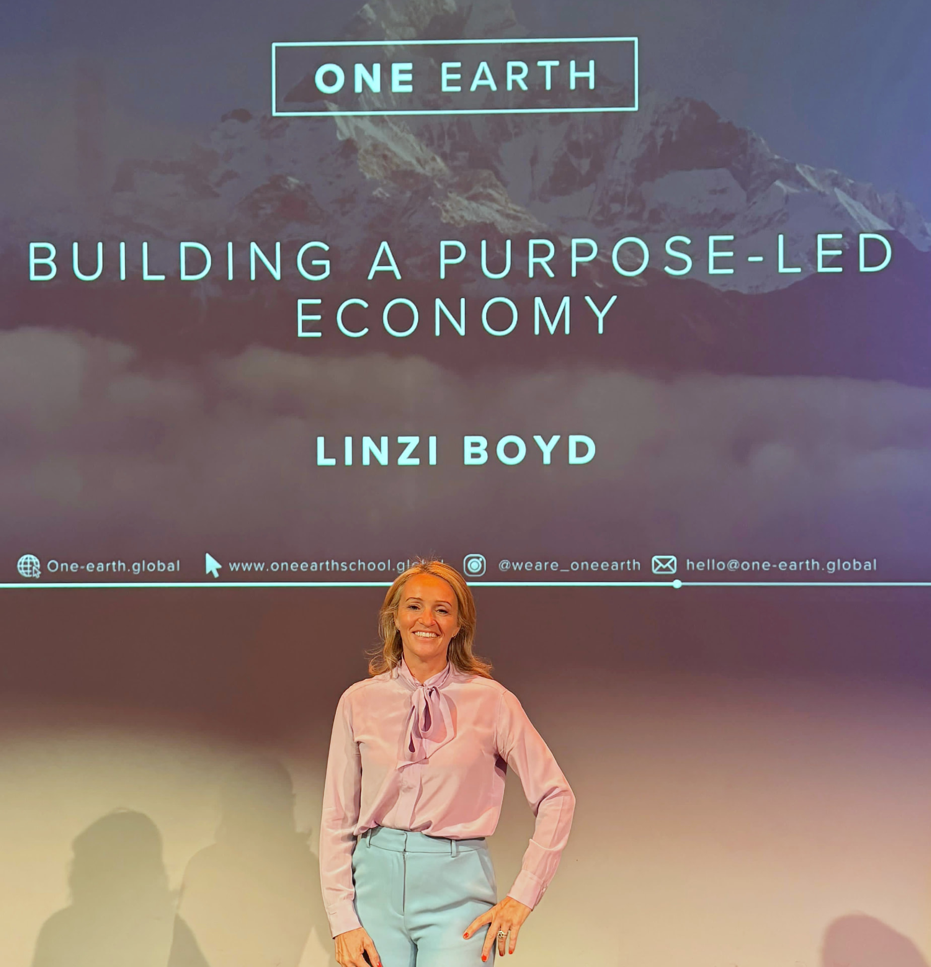 Linzi Boyd, Founder of One Earth Global, speaking on stage